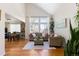 Bright living room with hardwood floors, vaulted ceilings, and large windows at 16225 Peregrine Dr, Parker, CO 80134