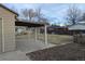 Backyard featuring a concrete patio, covered area, and ample lawn space at 6528 S Louthan St, Littleton, CO 80120