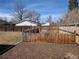 View of the fenced backyard area with mulch, ready for new landscaping at 6528 S Louthan St, Littleton, CO 80120