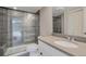 Modern bathroom with glass shower, gray tile, white vanity, and stylish fixtures at 6528 S Louthan St, Littleton, CO 80120