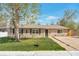 Charming one-story home featuring a well-manicured lawn and neutral siding at 6528 S Louthan St, Littleton, CO 80120
