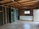 Unfinished garage with shelving units, cabinets and workbench area offering ample storage and work space at 6528 S Louthan St, Littleton, CO 80120