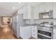 Bright kitchen with white cabinets, stainless appliances, and gray countertops at 6528 S Louthan St, Littleton, CO 80120