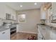Bright kitchen with stainless steel oven and granite countertops at 6528 S Louthan St, Littleton, CO 80120