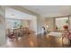 Open-concept living and dining area with hardwood floors and lots of light at 6528 S Louthan St, Littleton, CO 80120