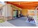 Attractive backyard patio with a wood ceiling and sliding glass doors to the home's interior at 11420 E 1St Ave, Aurora, CO 80010