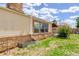Backyard with a stone foundation, well-maintained lawn, and an in-ground drain at 11420 E 1St Ave, Aurora, CO 80010