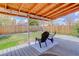 Comfortable backyard patio with a wood deck, chairs, and a view of the fenced yard at 11420 E 1St Ave, Aurora, CO 80010