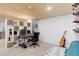 Finished basement area with desk, storage shelves and a decorative guitar at 11420 E 1St Ave, Aurora, CO 80010