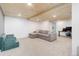 Spacious carpeted basement with coffered ceiling and a gray sectional sofa at 11420 E 1St Ave, Aurora, CO 80010