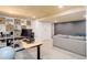 Spacious carpeted basement featuring desk and storage in finished area at 11420 E 1St Ave, Aurora, CO 80010