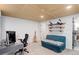 Finished basement area with desk, office chair, and recreational display at 11420 E 1St Ave, Aurora, CO 80010