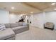 Spacious carpeted basement with coffered ceiling and casual seating at 11420 E 1St Ave, Aurora, CO 80010