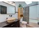 Cozy bathroom with wood-like vessel sink, patterned shower curtain, and tub at 11420 E 1St Ave, Aurora, CO 80010