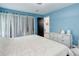 Serene bedroom showcasing a bed, a dresser, and soft blue walls creating a cozy and welcoming atmosphere at 11420 E 1St Ave, Aurora, CO 80010