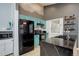 Modern kitchen with black appliances, marbled countertops, and stylish cabinetry at 11420 E 1St Ave, Aurora, CO 80010