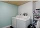 Functional laundry room featuring a white washer and dryer set and ample storage space at 11420 E 1St Ave, Aurora, CO 80010
