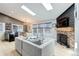 Open-concept living room with fireplace and large windows at 11420 E 1St Ave, Aurora, CO 80010