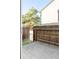 Back patio with a wood fence and an open gate at 3855 S Monaco Pkwy # 106, Denver, CO 80237