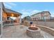 Spacious backyard with covered patio, built-in grill, and inviting fire pit area at 8371 S Cody Way, Littleton, CO 80128
