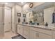 Bright bathroom featuring double vanity with granite countertop and glass shower at 8371 S Cody Way, Littleton, CO 80128