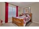 Cozy bedroom featuring a wooden bed frame and large window with red curtains at 8371 S Cody Way, Littleton, CO 80128