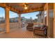 Relaxing covered patio features outdoor seating and recessed lighting with ceiling fan at 8371 S Cody Way, Littleton, CO 80128