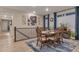 Elegant dining room with a sophisticated chandelier, large windows, and seamlessly connects to the adjacent living space at 8371 S Cody Way, Littleton, CO 80128