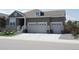Lovely single-Gathering home with a three car garage, manicured front yard and a covered front porch with stone details at 8371 S Cody Way, Littleton, CO 80128