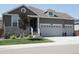 Attractive single-Gathering home with a three car garage, stone accents, manicured front yard and a covered front porch at 8371 S Cody Way, Littleton, CO 80128