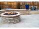 Inviting outdoor fire pit, landscape wall and water feature in a well-kept backyard at 8371 S Cody Way, Littleton, CO 80128
