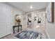 Inviting foyer featuring sleek wood floors, stylish decor, and an open view into the spacious layout of the home at 8371 S Cody Way, Littleton, CO 80128