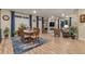 Open-concept living and dining areas with stylish furnishings, a cozy fireplace, and seamless access to outdoor spaces at 8371 S Cody Way, Littleton, CO 80128