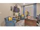 Inviting home office features two cozy armchairs, desk and large screen TV at 8371 S Cody Way, Littleton, CO 80128