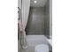Cozy bathroom with gray subway tile shower and tub combination, accented by a patterned shower curtain at 10864 Lyric St, Lone Tree, CO 80134