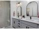 Modern bathroom features double sinks, sleek faucets, gray vanity, and a glass enclosed shower at 10864 Lyric St, Lone Tree, CO 80134
