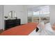 Bright bedroom with wood floors and a sliding glass door that opens to a balcony with a lovely view at 10864 Lyric St, Lone Tree, CO 80134