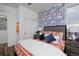 Inviting bedroom with a trendy wallpaper, wood floors, and comfortable bed with blue accent pillows at 10864 Lyric St, Lone Tree, CO 80134
