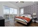 Bright bedroom with a walkout balcony overlooking a beautiful view, stylish light fixture, and wood flooring at 10864 Lyric St, Lone Tree, CO 80134