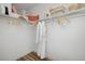 Well-organized closet with wooden hangers, storage baskets, and a long white robe at 10864 Lyric St, Lone Tree, CO 80134