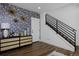 Stylish entryway with decorative wallpaper, console table, and black metal staircase railing at 10864 Lyric St, Lone Tree, CO 80134