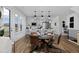 Modern living space features a kitchen with pendant lighting adjacent to a dining area with sleek, modern furniture at 10864 Lyric St, Lone Tree, CO 80134
