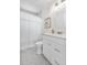Bathroom with a white vanity, modern fixtures, patterned tile floor, and a shower-tub combo at 111 Wolff St, Denver, CO 80219
