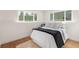 Cozy bedroom with plush bedding, wood floors and bright natural light from two windows at 111 Wolff St, Denver, CO 80219