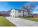 Charming home with a large driveway, manicured lawn, and a well-maintained white exterior at 111 Wolff St, Denver, CO 80219