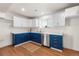 Modern kitchen featuring custom blue cabinets, white countertops, stainless steel appliances, and hardwood floors at 111 Wolff St, Denver, CO 80219