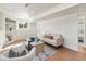 Bright living room with modern furniture, built-in shelving, and large windows for ample light at 111 Wolff St, Denver, CO 80219