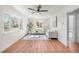 Bright living room with hardwood floors, a ceiling fan, and large windows showcasing the outside view at 111 Wolff St, Denver, CO 80219