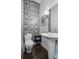 Stylish powder room featuring mosaic tile accent wall and pedestal sink at 3444 Navajo St # 10, Denver, CO 80211