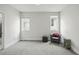 Bright bedroom with two windows, neutral carpet, and cozy seating area at 3444 Navajo St # 10, Denver, CO 80211